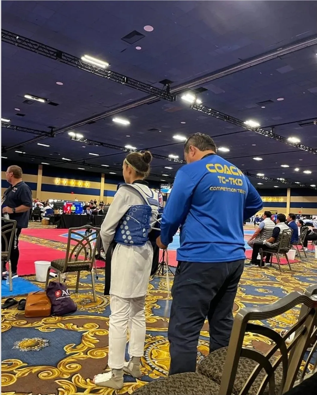 Coach de TC Taekwondo con una atleta del equipo de competencia durante un torneo